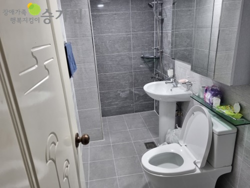 주거환경개선사업에 선정되어 장애가족이 살고 있는 가정집의 화장실이 전보다 편리하게 개선된 사진. 장애가족행복지킴이ci.